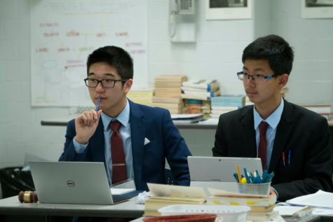 2 members of BCA Model United Nations during their delegations presentation.
