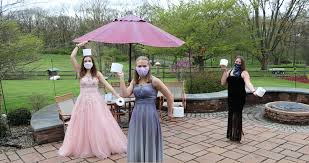 Image of three students from central Pennsylvania wearing masks and prom dresses